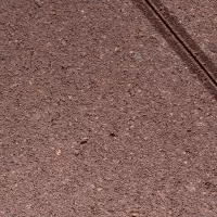 Плитка тротуарная оранжевого цвета на сером цементе